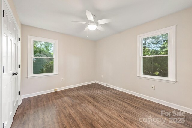 3101 Willowbrae Rd, Charlotte, NC 28226 - unfurnished bedroom with multiple windows, dark wood-style floors, and baseboards
