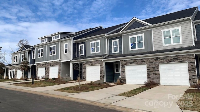 2535 Ruby Dixon Crossing Dr Unit 19, Gastonia, NC 28056 - view of property featuring stone siding, an attached garage, driveway, and board and batten siding