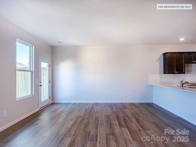 2535 Ruby Dixon Crossing Dr Unit 19, Gastonia, NC 28056 - unfurnished living room with healthy amount of natural light and wood finished floors