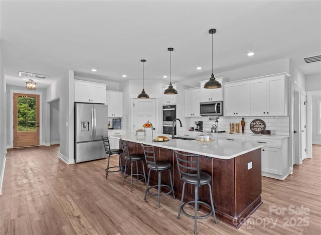 LOT101 Coppergate Dr, Salisbury, NC 28147 - kitchen with stainless steel appliances, decorative backsplash, light countertops, white cabinetry, and recessed lighting