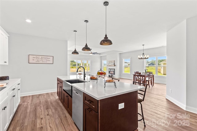 LOT101 Coppergate Dr, Salisbury, NC 28147 - kitchen featuring dishwasher, light wood-type flooring, a breakfast bar, dark brown cabinetry, and recessed lighting