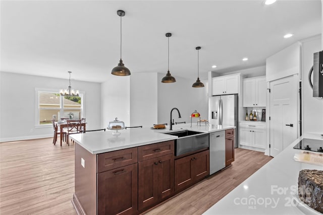LOT101 Coppergate Dr, Salisbury, NC 28147 - kitchen featuring stainless steel appliances, light countertops, light wood finished floors, white cabinetry, and an island with sink