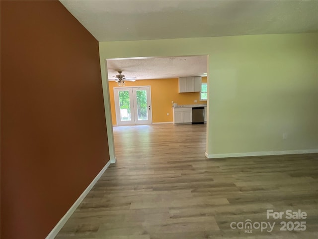 152 Mountainview St, Forest City, NC 28043 - unfurnished living room featuring baseboards, light wood-style flooring, ceiling fan, and a textured ceiling