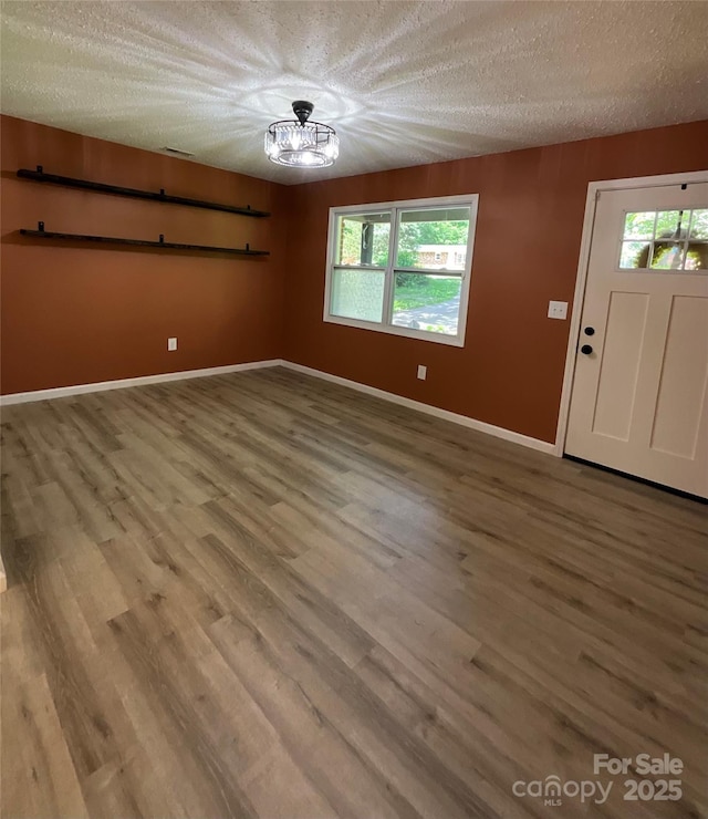 152 Mountainview St, Forest City, NC 28043 - foyer entrance featuring wood finished floors, a textured ceiling, plenty of natural light, and baseboards