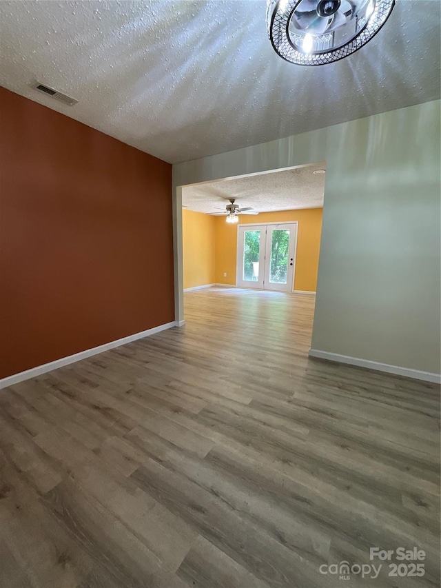 152 Mountainview St, Forest City, NC 28043 - unfurnished living room with wood finished floors, a textured ceiling, baseboards, and ceiling fan