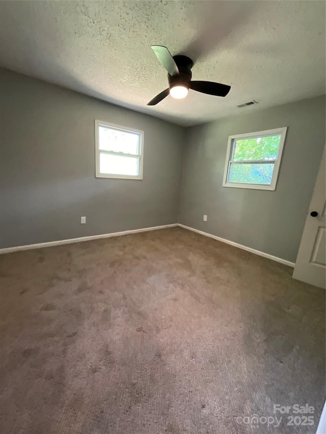 152 Mountainview St, Forest City, NC 28043 - unfurnished room featuring plenty of natural light, carpet flooring, baseboards, a textured ceiling, and a ceiling fan