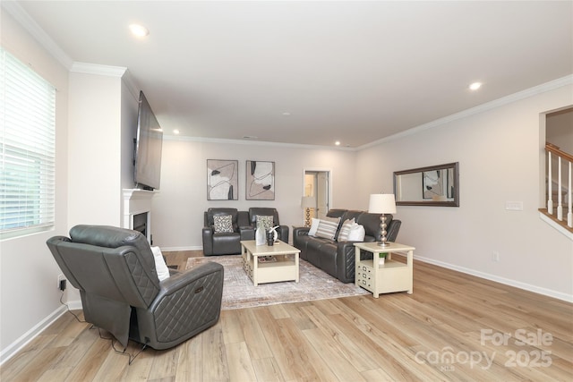 1119 Bellshill Dr, Indian Trail, NC 28079 - living area featuring stairway, a fireplace, light wood-type flooring, healthy amount of natural light, and crown molding