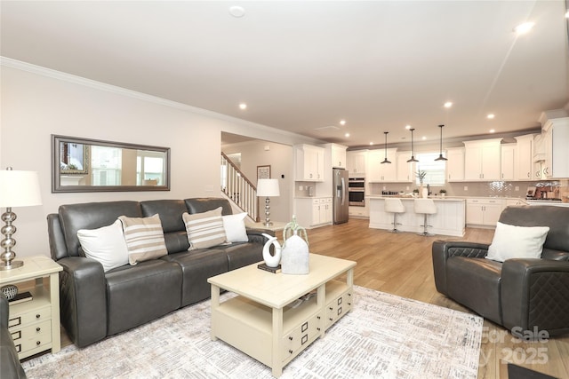 1119 Bellshill Dr, Indian Trail, NC 28079 - living area with ornamental molding, light wood finished floors, recessed lighting, and stairs