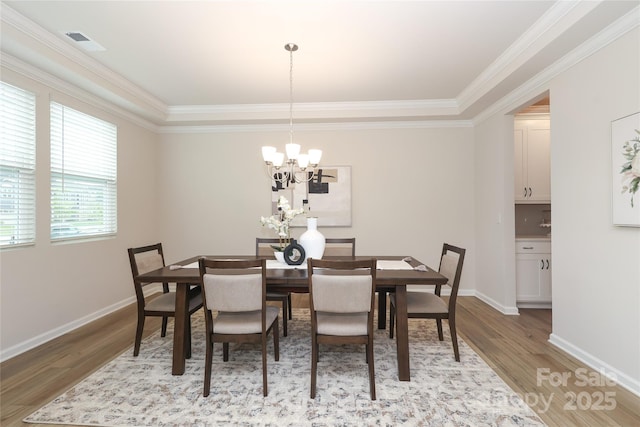 1119 Bellshill Dr, Indian Trail, NC 28079 - dining area with wood finished floors, ornamental molding, a chandelier, and baseboards