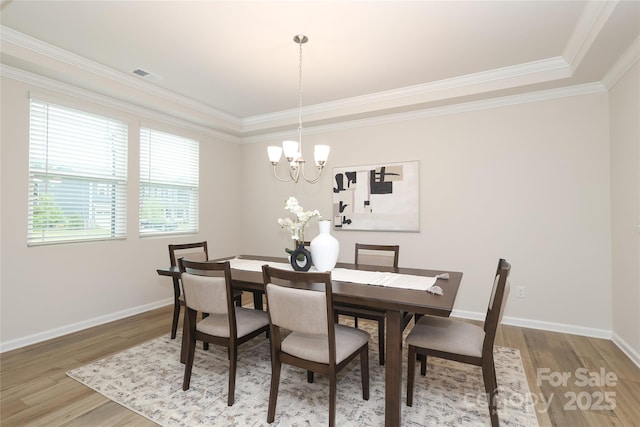 1119 Bellshill Dr, Indian Trail, NC 28079 - dining room with wood finished floors, crown molding, a chandelier, and baseboards