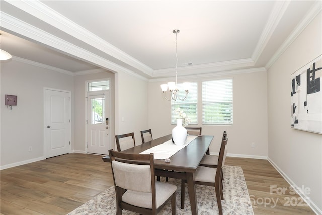 1119 Bellshill Dr, Indian Trail, NC 28079 - dining space with light wood finished floors, a chandelier, ornamental molding, and baseboards