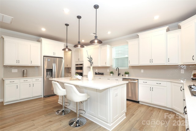 1119 Bellshill Dr, Indian Trail, NC 28079 - kitchen featuring appliances with stainless steel finishes, a sink, backsplash, a kitchen island, and ornamental molding
