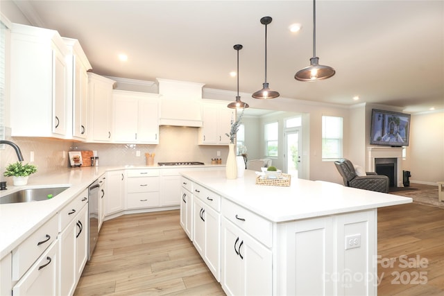 1119 Bellshill Dr, Indian Trail, NC 28079 - kitchen with a sink, ornamental molding, a center island, open floor plan, and light wood-style flooring
