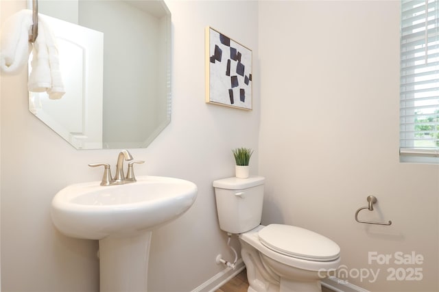 1119 Bellshill Dr, Indian Trail, NC 28079 - bathroom featuring toilet, wood finished floors, baseboards, and a sink