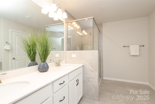1119 Bellshill Dr, Indian Trail, NC 28079 - full bath with a stall shower, double vanity, baseboards, a chandelier, and marble finish floors
