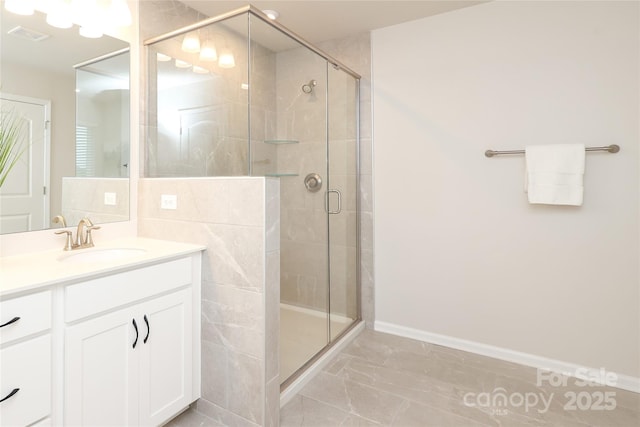 1119 Bellshill Dr, Indian Trail, NC 28079 - bathroom with marble look tile flooring, a shower stall, vanity, and baseboards