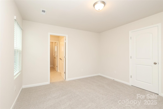 1119 Bellshill Dr, Indian Trail, NC 28079 - unfurnished bedroom featuring light colored carpet, baseboards, and connected bathroom