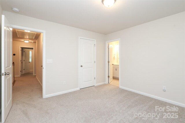 1119 Bellshill Dr, Indian Trail, NC 28079 - unfurnished bedroom featuring attic access, light colored carpet, baseboards, and ensuite bathroom