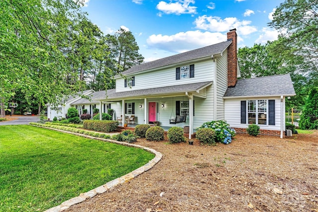 8218 Bright Water Ln, Denver, NC 28037 - view of front of house featuring a chimney, a porch, a front lawn, and a shingled roof