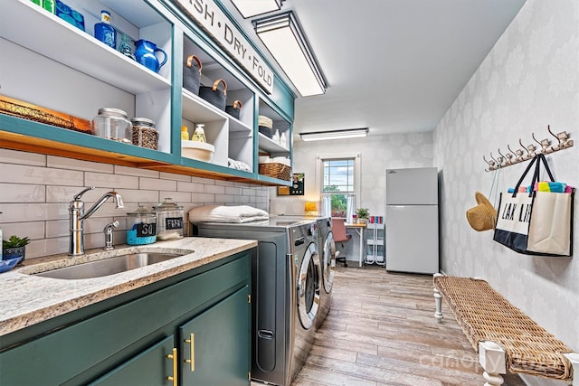 8218 Bright Water Ln, Denver, NC 28037 - washroom featuring light wood-type flooring, independent washer and dryer, and cabinet space