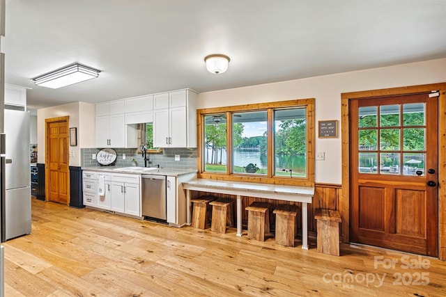 8218 Bright Water Ln, Denver, NC 28037 - kitchen with a sink, appliances with stainless steel finishes, plenty of natural light, and wainscoting