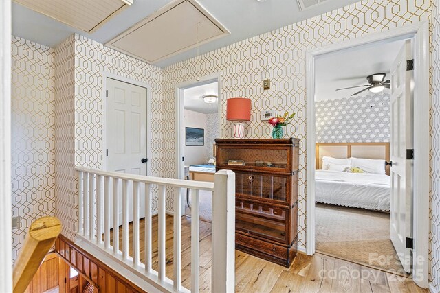 8218 Bright Water Ln, Denver, NC 28037 - corridor featuring attic access, wallpapered walls, and wood finished floors