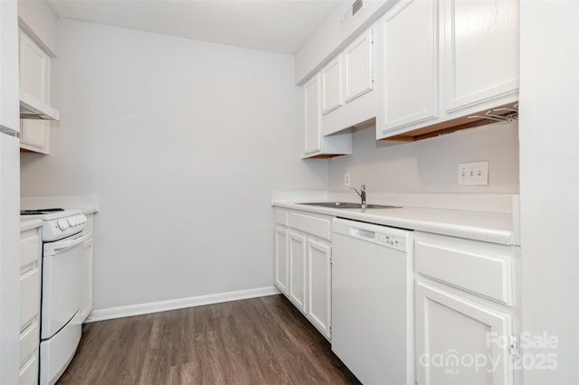 kitchen featuring white appliances, a sink, under cabinet range hood, dark wood finished floors, and white cabinets