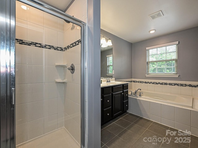 bathroom with tile patterned flooring, a bath, a stall shower, vanity, and recessed lighting