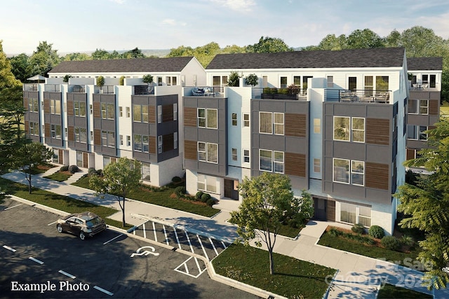 view of property featuring uncovered parking
