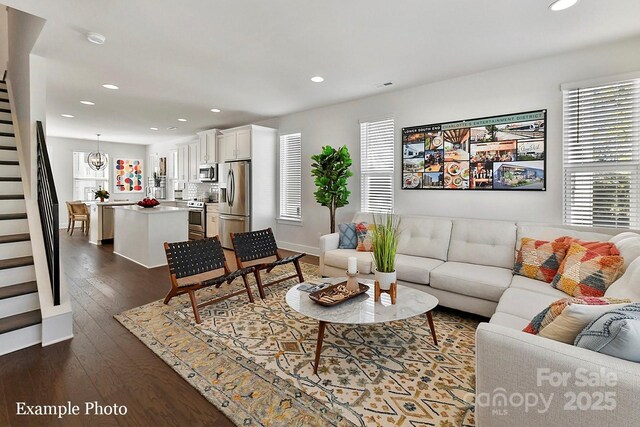 living area featuring stairway, recessed lighting, and dark wood finished floors