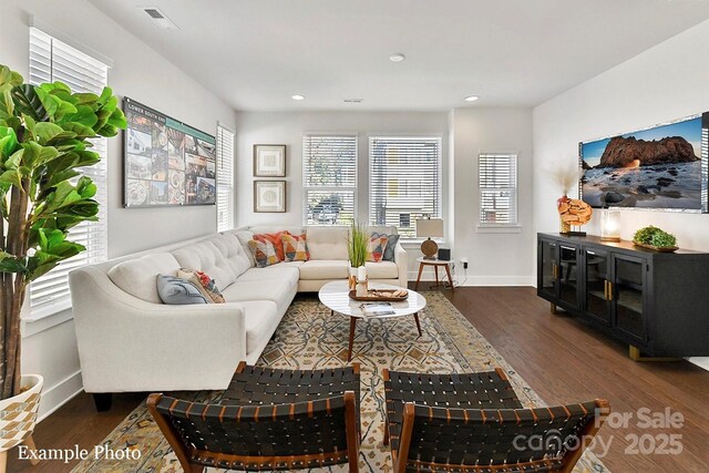 living room with wood finished floors, recessed lighting, and baseboards