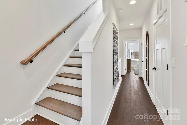 stairway featuring recessed lighting, wood finished floors, and baseboards