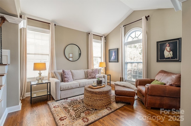living room with wood finished floors, lofted ceiling, and baseboards