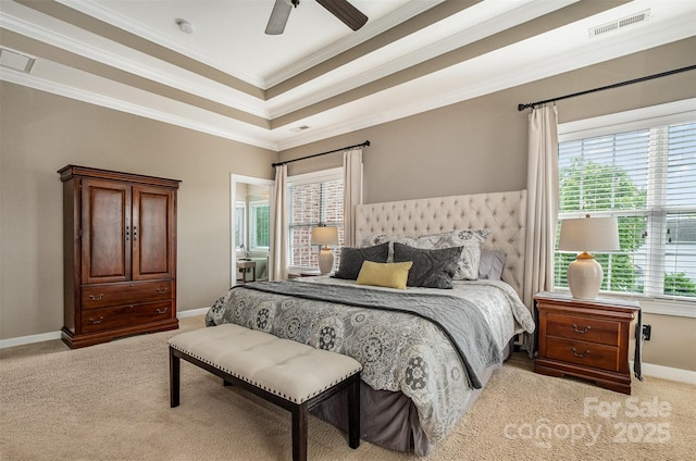 carpeted bedroom with crown molding, baseboards, a raised ceiling, and ceiling fan