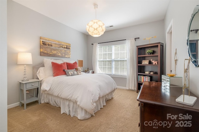 bedroom featuring light carpet and baseboards