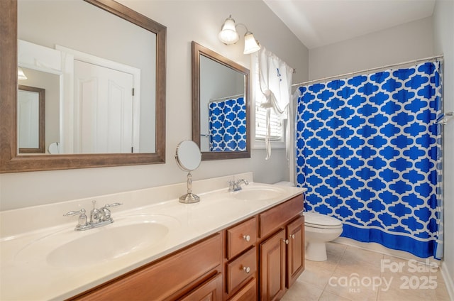 full bathroom featuring tile patterned flooring, double vanity, and toilet