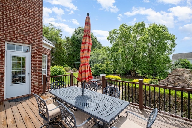 wooden terrace featuring outdoor dining area