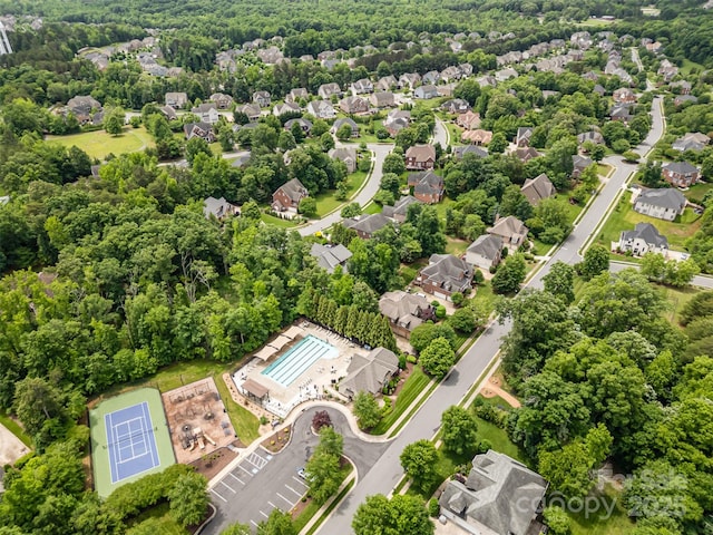 aerial perspective of suburban area featuring a pool