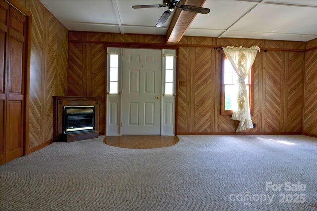 7 Lakewood Rd, Hendersonville, NC 28792 - entrance foyer with wood walls, carpet floors, a glass covered fireplace, and a ceiling fan