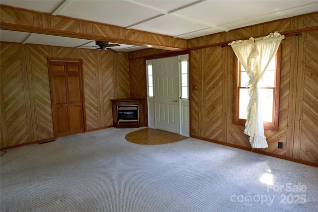 7 Lakewood Rd, Hendersonville, NC 28792 - entryway featuring a glass covered fireplace, ceiling fan, wooden walls, carpet, and baseboards