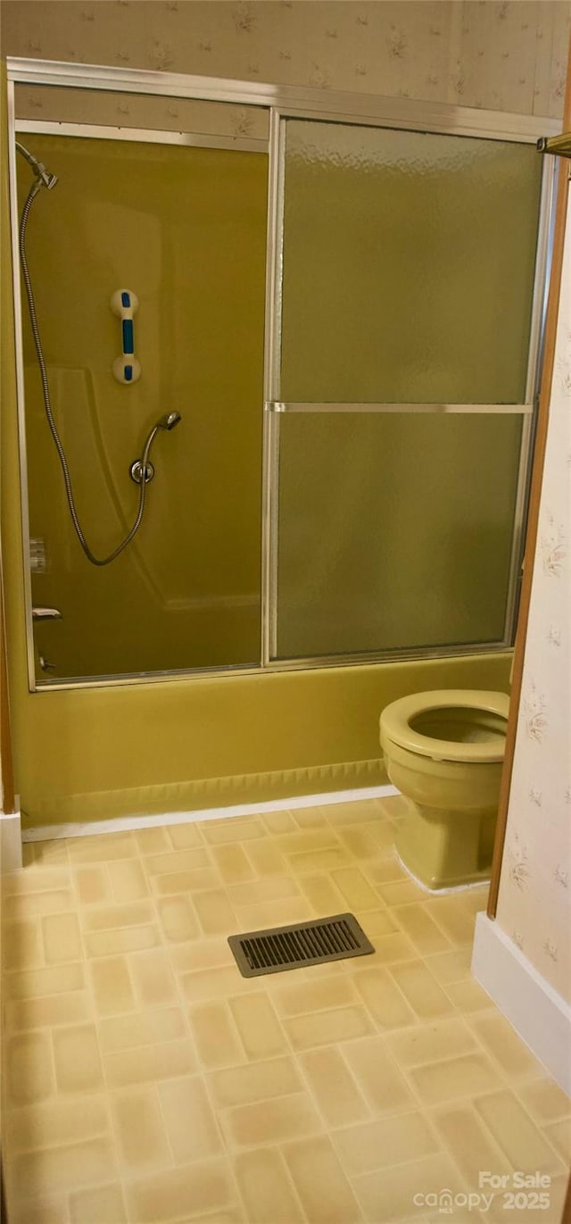 7 Lakewood Rd, Hendersonville, NC 28792 - full bathroom featuring wallpapered walls, toilet, enclosed tub / shower combo, and baseboards