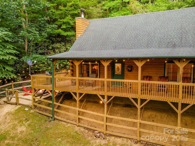 45 Ginger Ln, Waynesville, NC 28785 - view of front of home with a shingled roof, a chimney, a wooden deck, and log siding