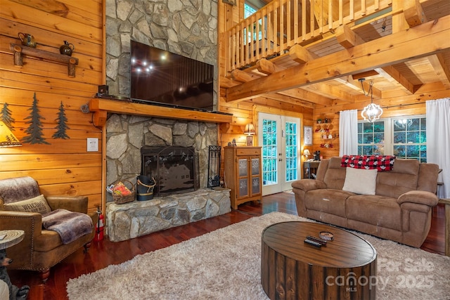 45 Ginger Ln, Waynesville, NC 28785 - living area with wood walls, wood finished floors, beamed ceiling, a fireplace, and french doors