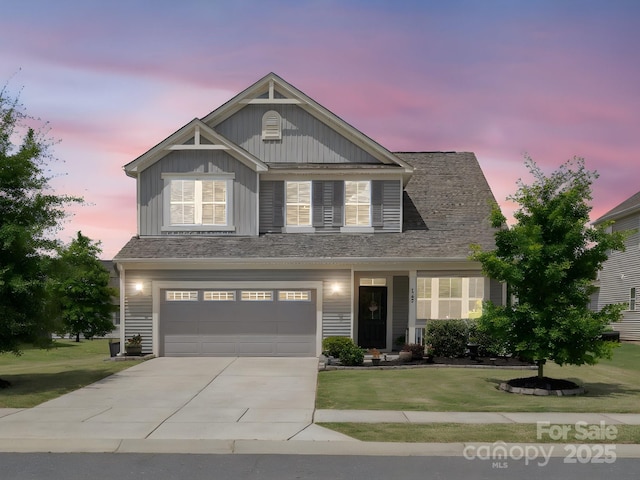1305 Kings Grove Dr, York, SC 29745 - view of front of property featuring board and batten siding, a front yard, concrete driveway, and a garage