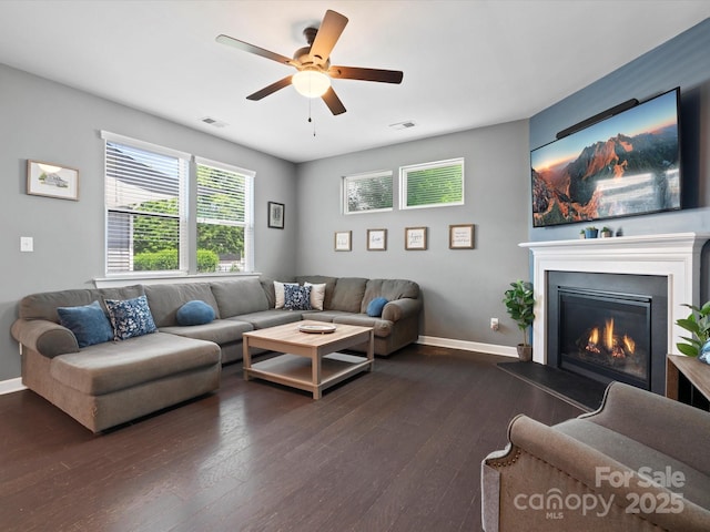 1305 Kings Grove Dr, York, SC 29745 - living room with dark wood finished floors, ceiling fan, a glass covered fireplace, and baseboards