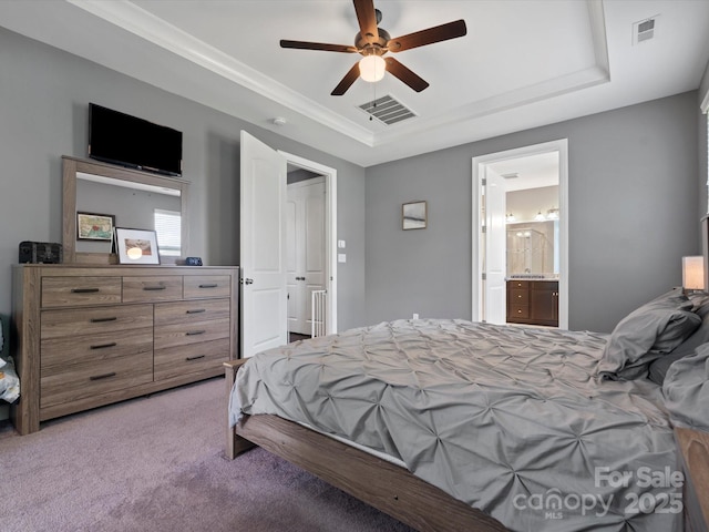 1305 Kings Grove Dr, York, SC 29745 - carpeted bedroom with a tray ceiling, a ceiling fan, and connected bathroom