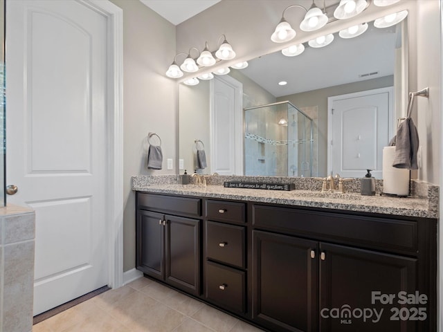 1305 Kings Grove Dr, York, SC 29745 - bathroom featuring a stall shower, tile patterned flooring, double vanity, and baseboards