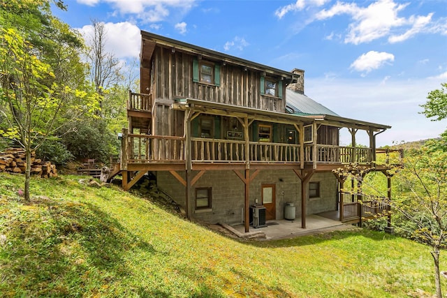 6338 W View Dr, Newland, NC 28657 - back of property featuring a patio area, a lawn, a chimney, and a deck