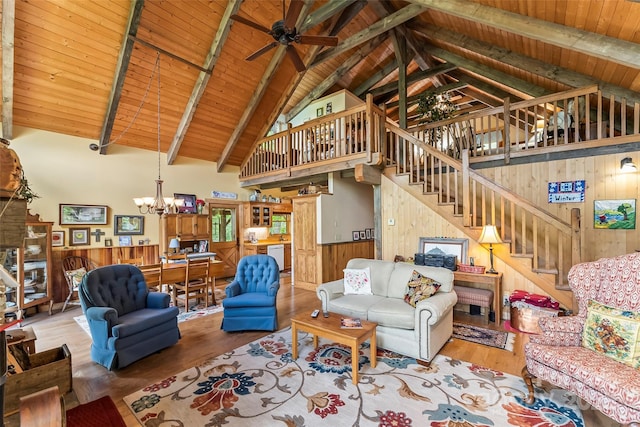6338 W View Dr, Newland, NC 28657 - living area featuring a chandelier, wood walls, wood finished floors, wood ceiling, and a ceiling fan