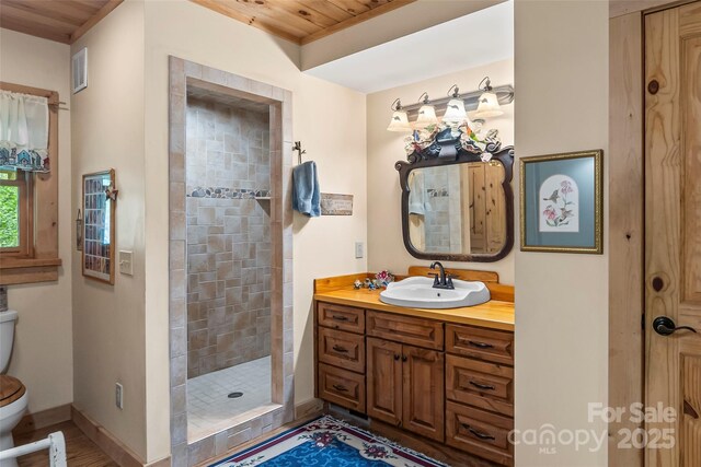 6338 W View Dr, Newland, NC 28657 - bathroom featuring wooden ceiling, toilet, a tile shower, vanity, and baseboards